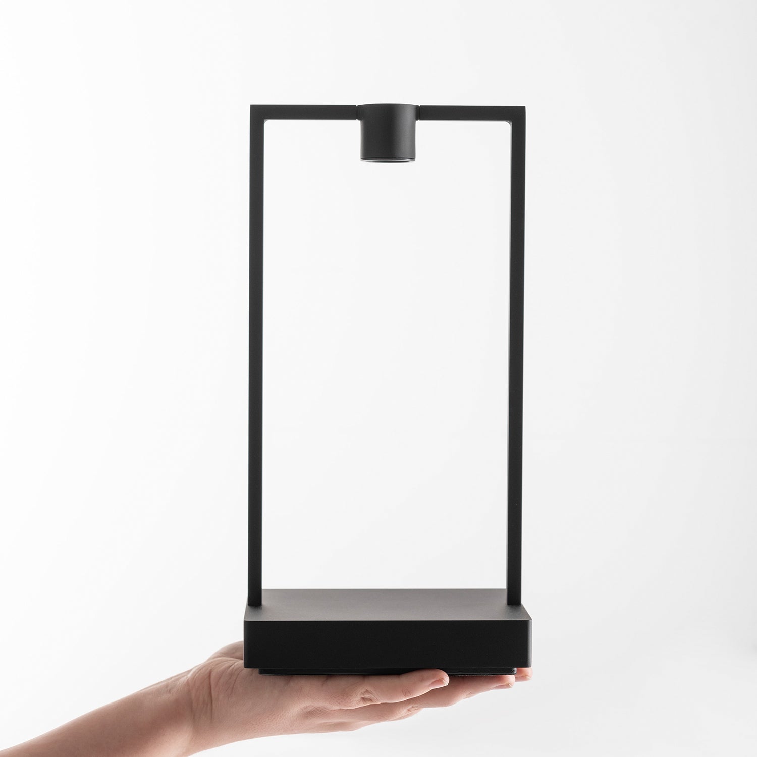 Artemide Curiosity 36 Portable Table Lamp in a hand