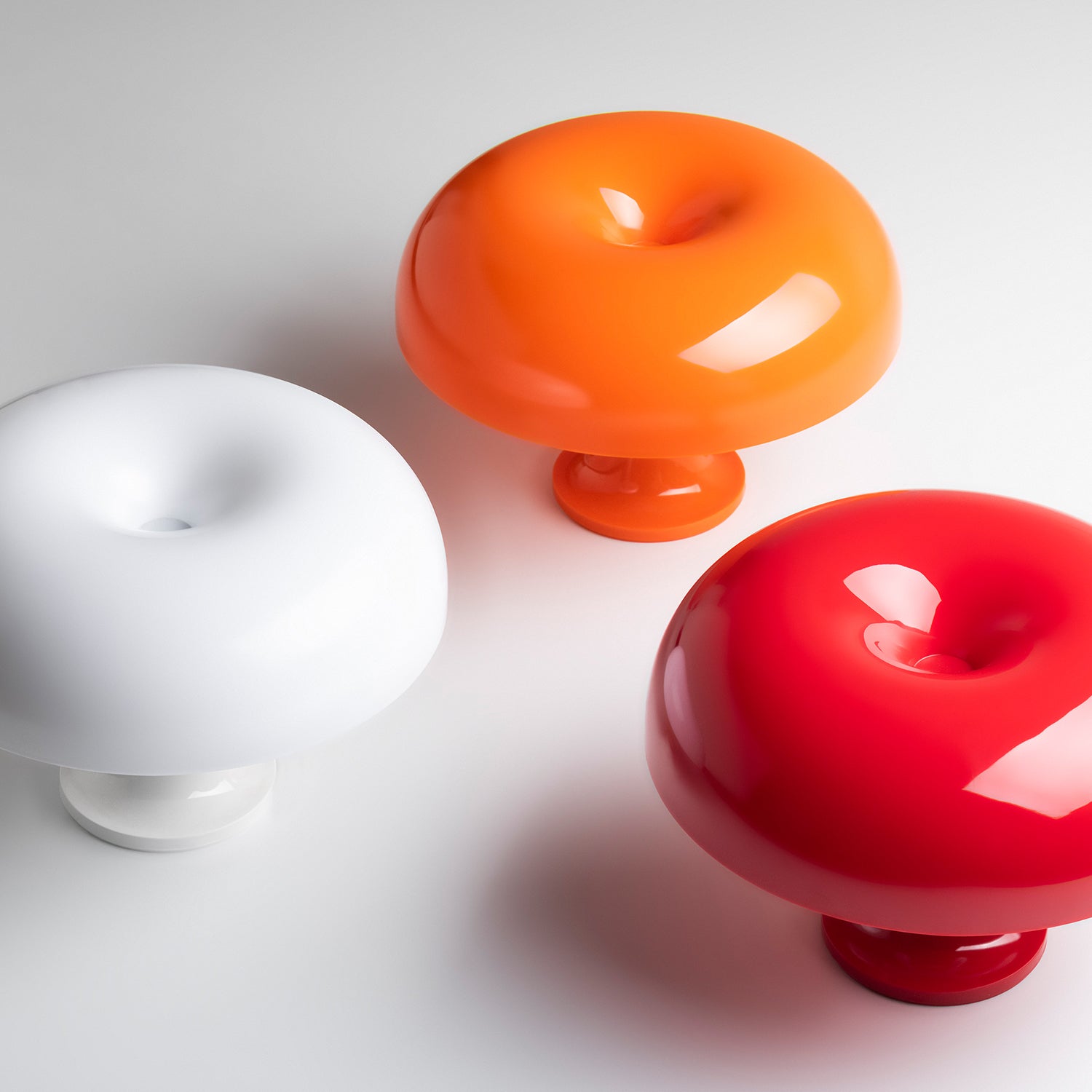 Artemide Nessino Table Lamps, showing red, orange & white