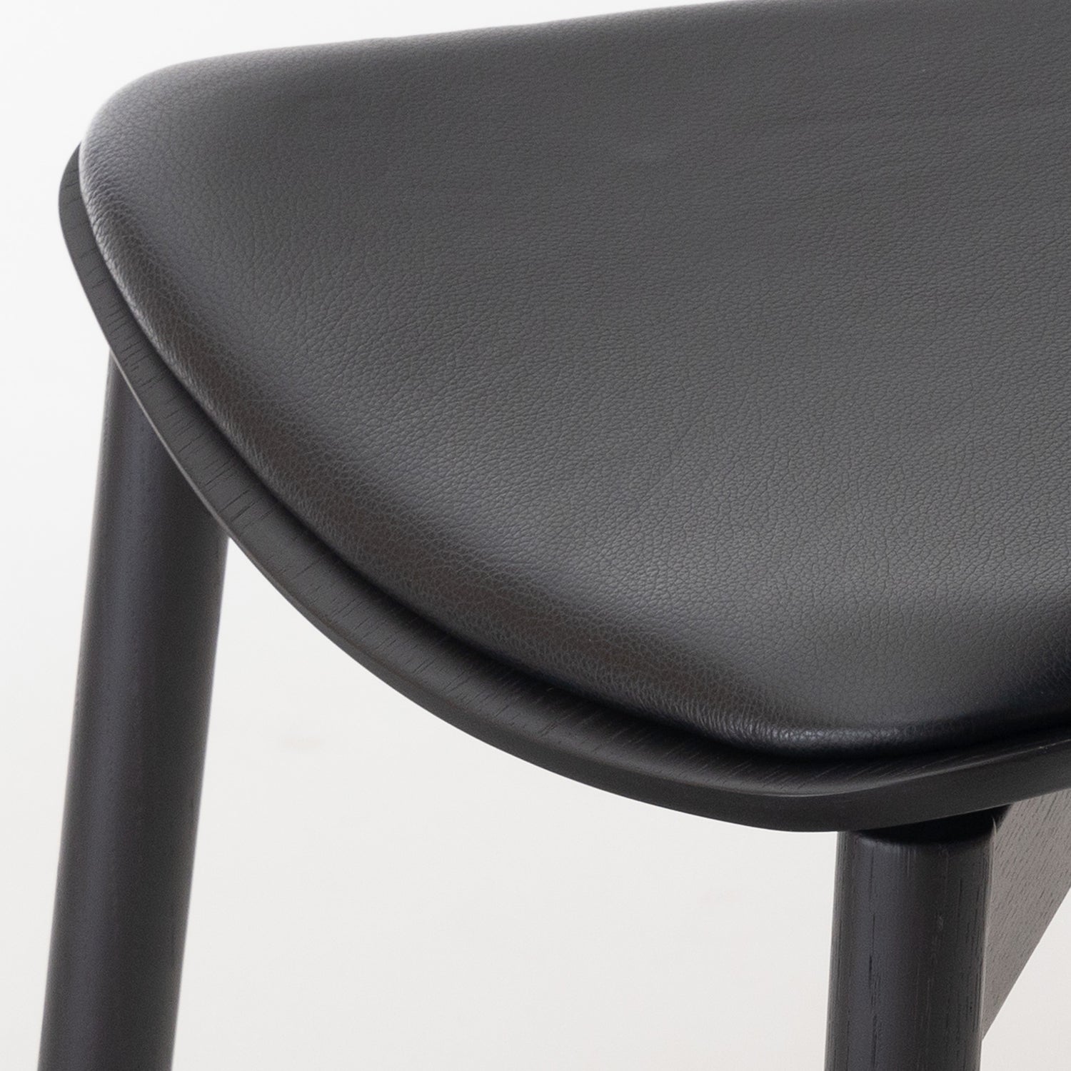 Otis Seat Upholstered Wood Chair in black oak and Black Leather seat detail