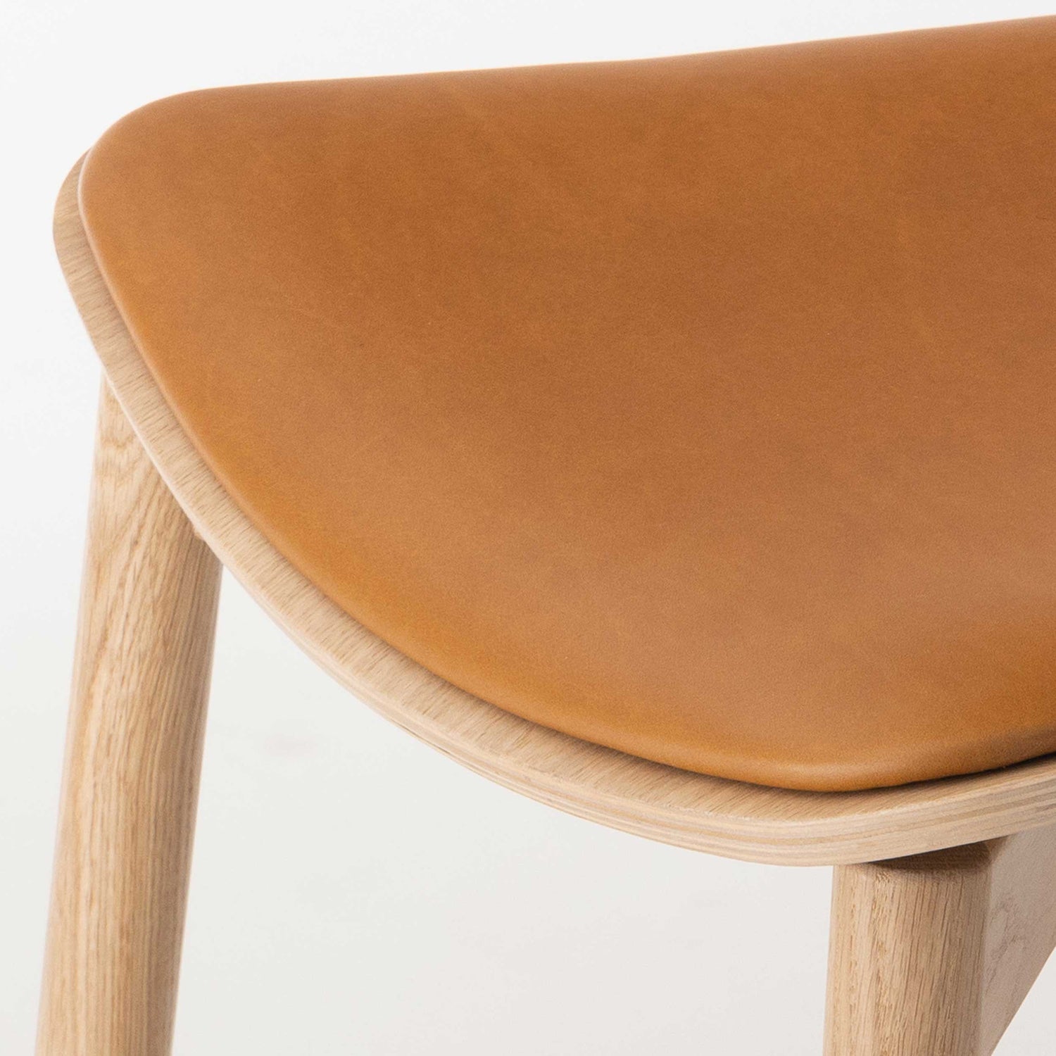 Otis Seat Upholstered Wood Chair in oak and cognac Leather seat detail