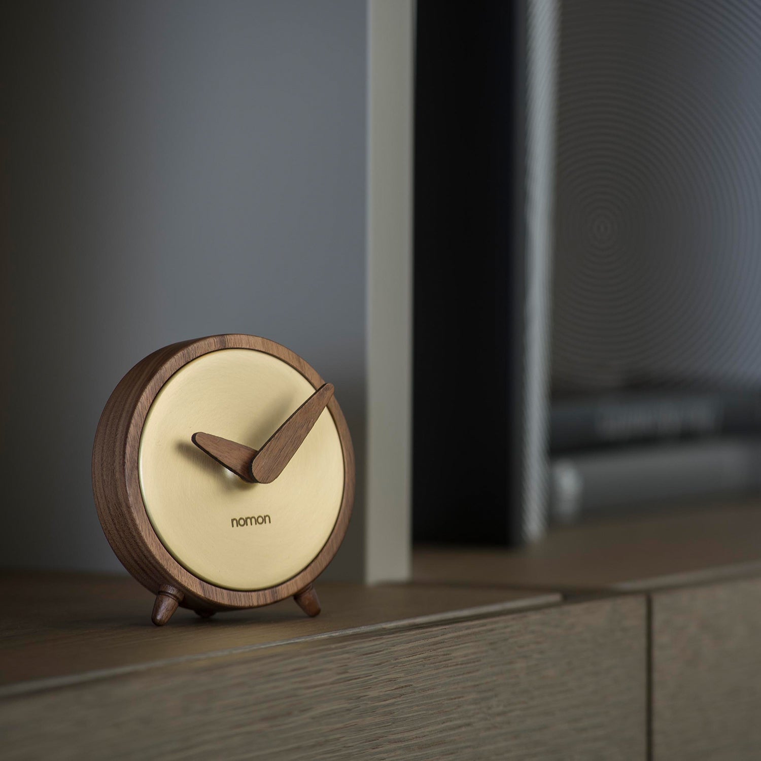 Nomon Atomo table clock in walnut and brass ambience image