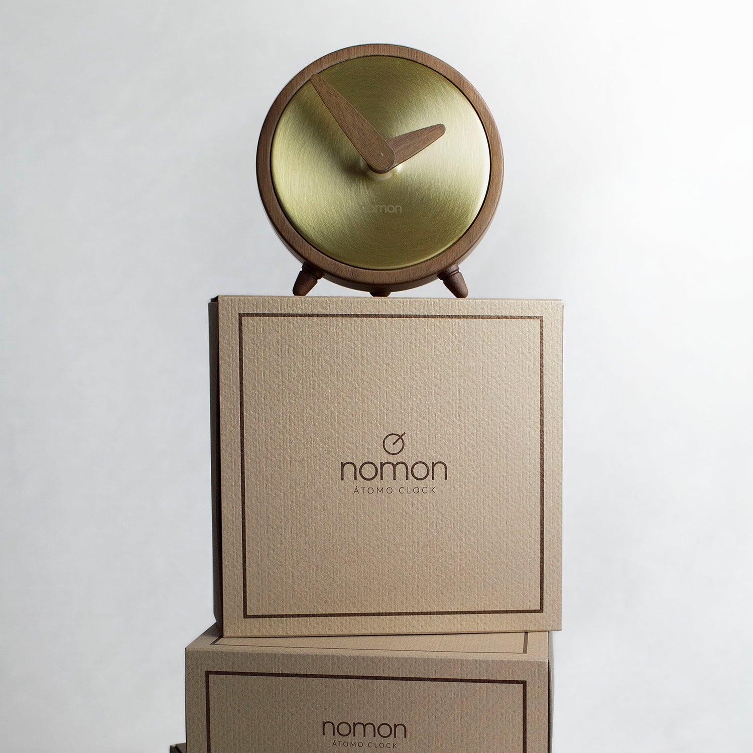 Nomon Atomo table clock in walnut and brass ambience image